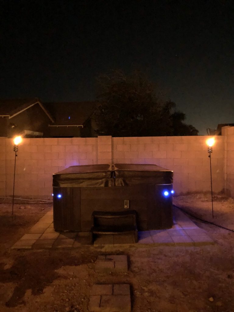 Hot tub with blue LED lights and Tiki torches