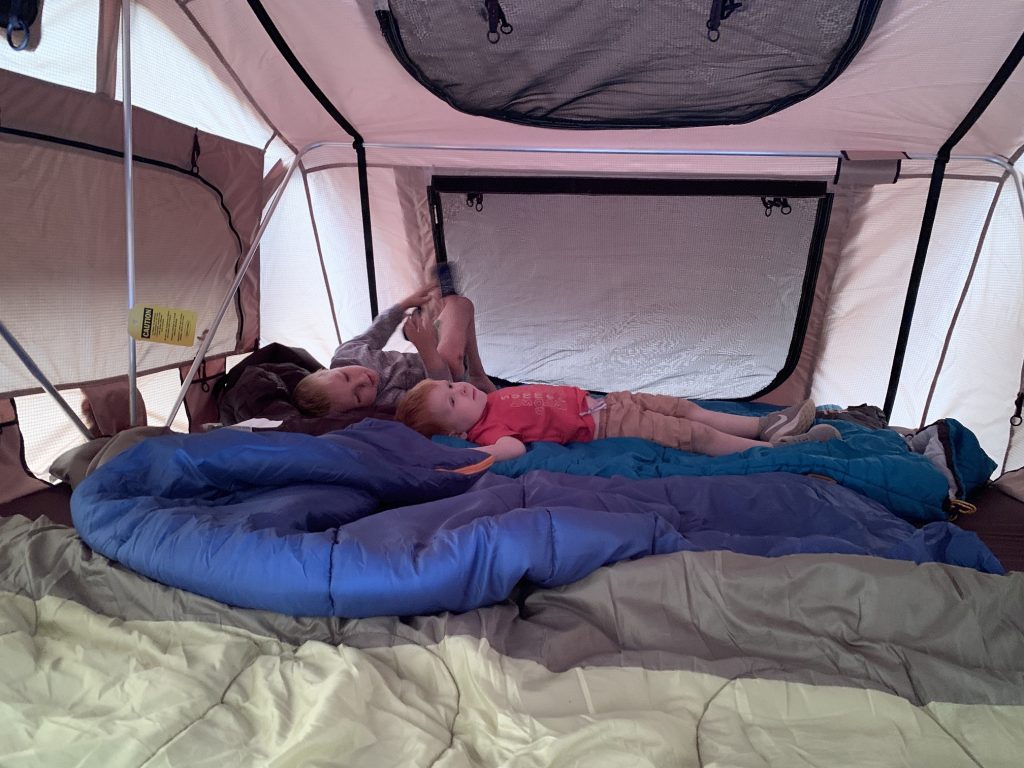 Two boys inside Smittybilt Overlander XL roof top tent