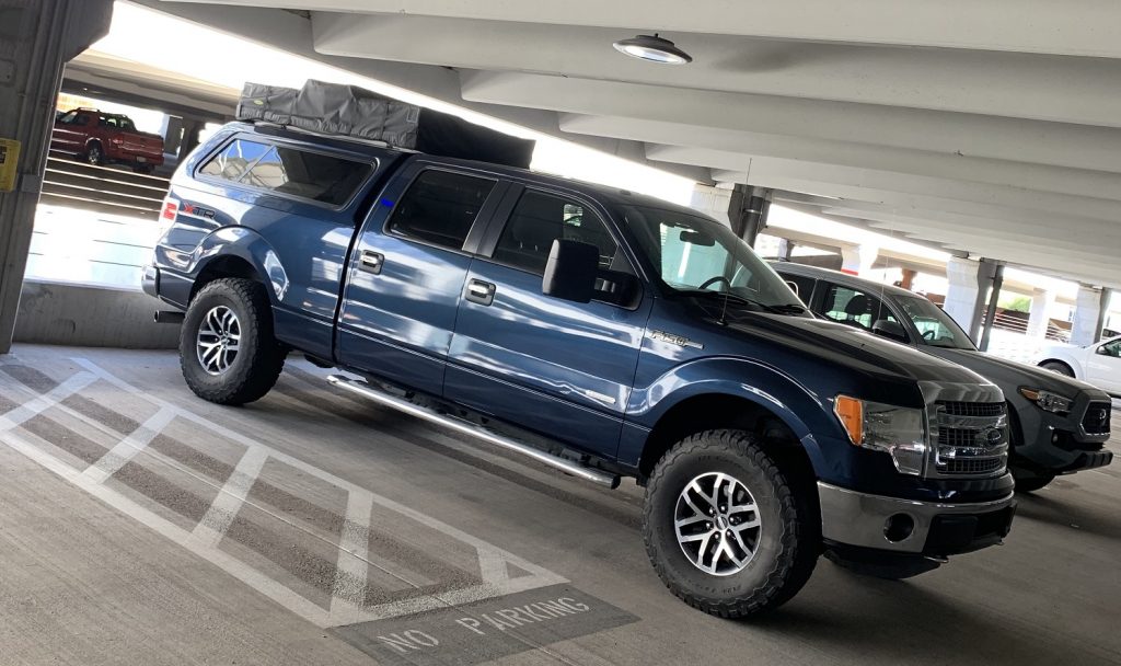 2014 F150 with Smittybilt roof top tent inside parking structure