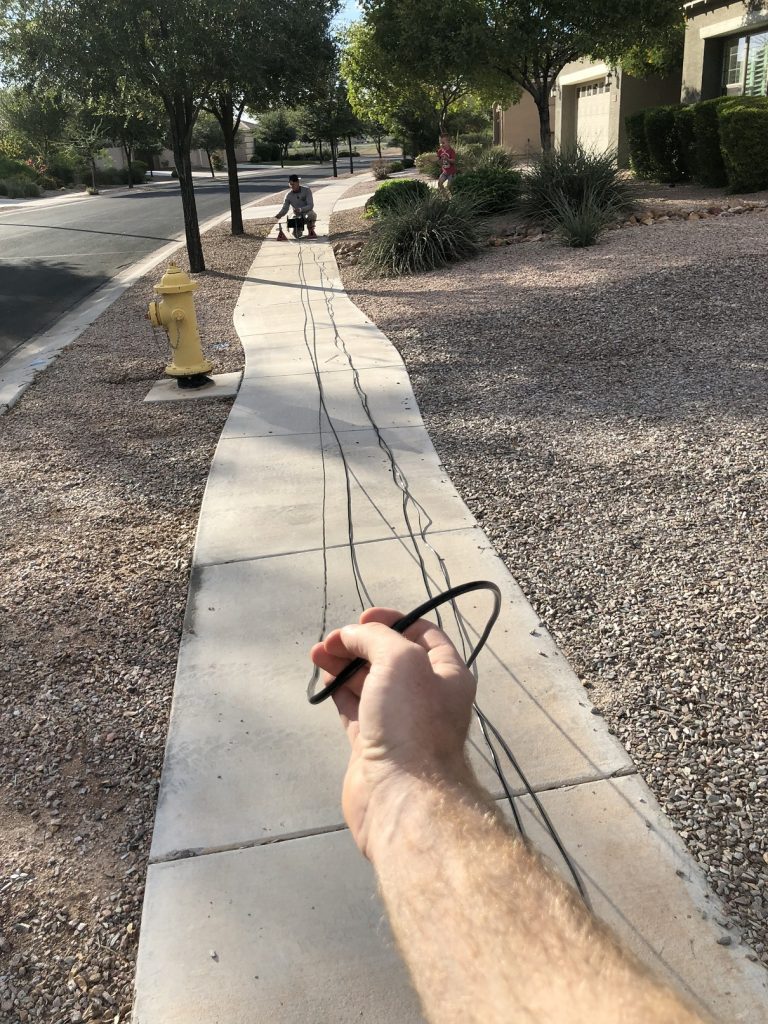 Pulling electrical wire on sidewalk to get 85 sections